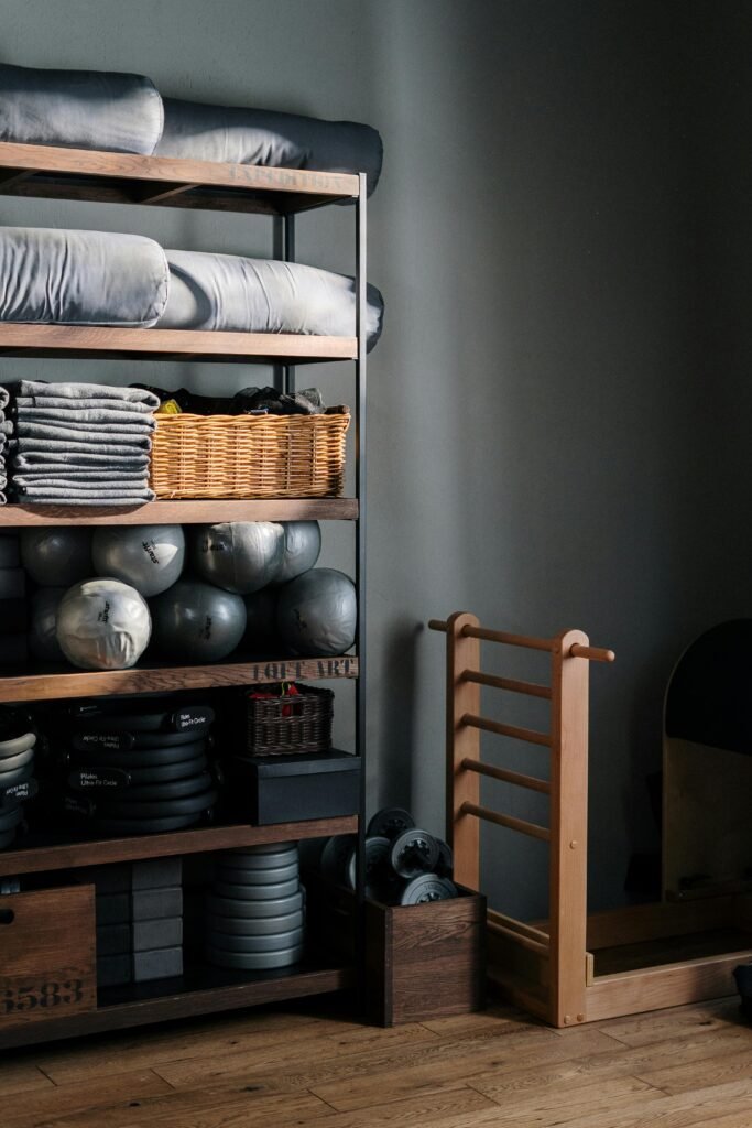 pexels photo 4327024 4327024 Neat arrangement of gym equipment and yoga mats in a modern fitness studio.